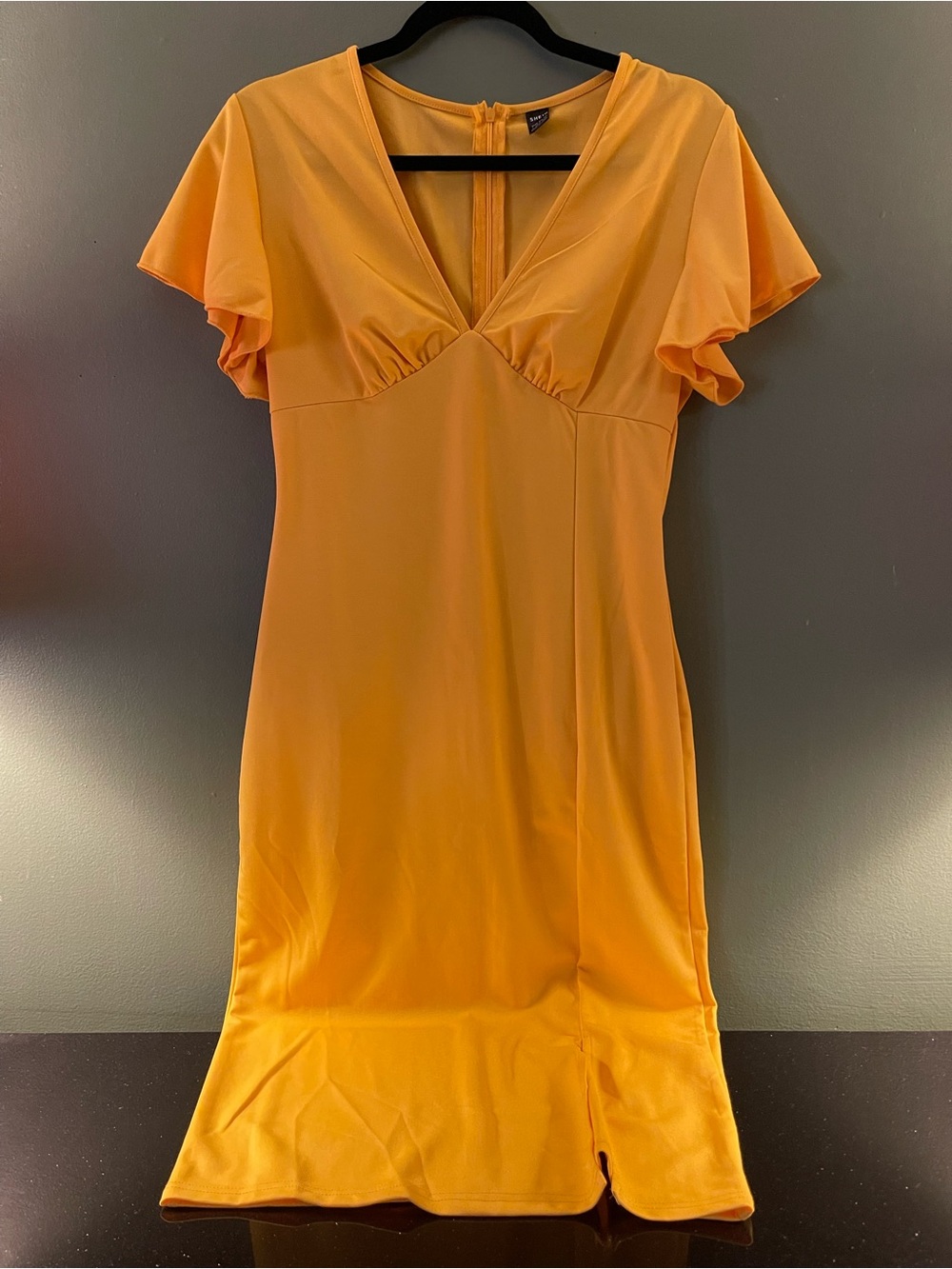 Yellow/orange short sleeve dress with slit on the side.